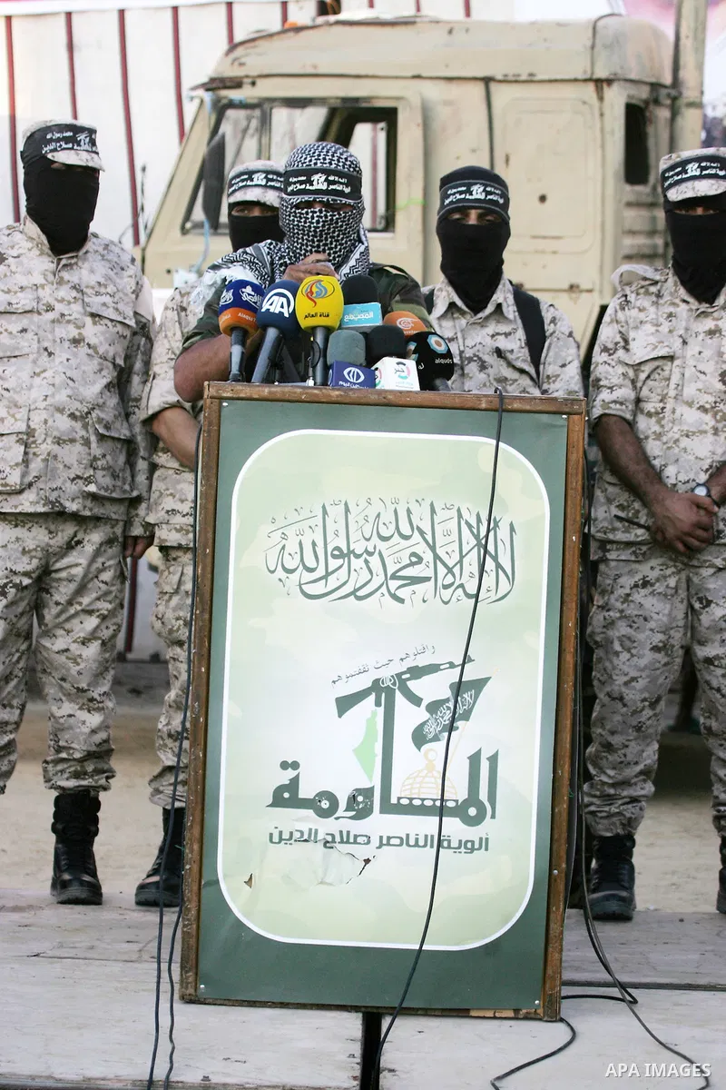 Palestinian militants from the Al-Nasser Brigades, an armed wing of the Popular Resistance Committees (PRC), take part during a rally in Rafah in the southern Gaza Strip on September 26, 2016, to mark the 17th anniversar...
