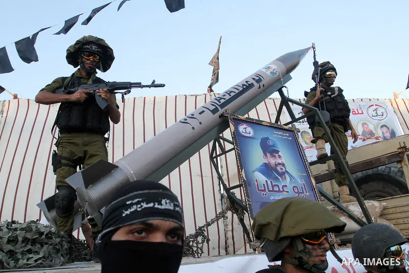 Palestinian militants from the Al-Nasser Brigades, an armed wing of the Popular Resistance Committees (PRC), stand next to home-made rockets during a rally in Rafah in the southern Gaza Strip on September 26, 2016, to ma...