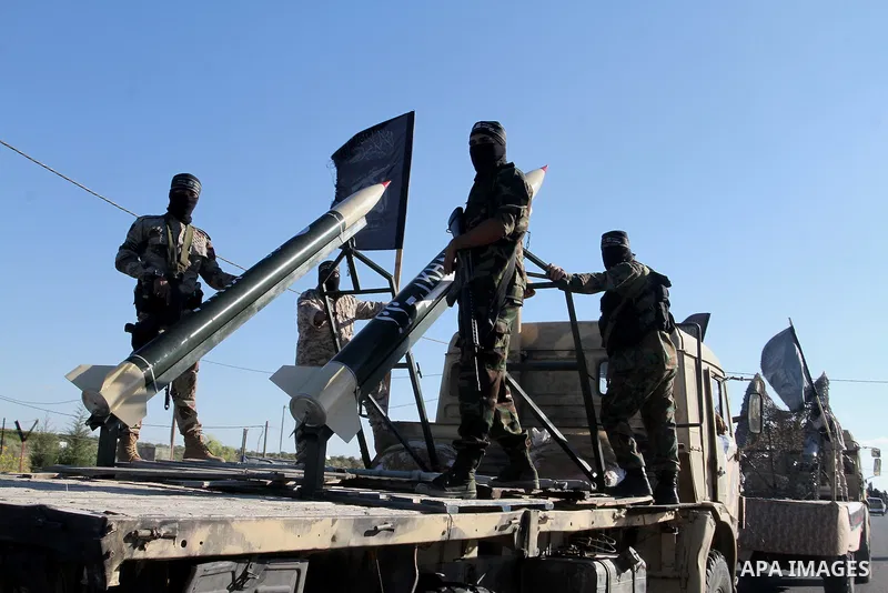Palestinian militants from the Al-Nasser Brigades, an armed wing of the Popular Resistance Committees (PRC), stand next to home-made rockets during a rally in Rafah in the southern Gaza Strip on September 26, 2016, to ma...