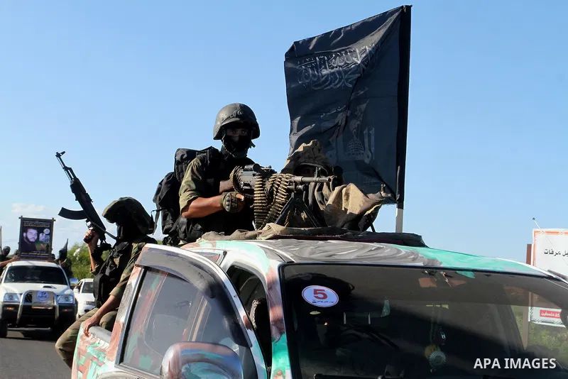 Palestinian militants from the Al-Nasser Brigades, an armed wing of the Popular Resistance Committees (PRC), hold their weapons during a rally in Rafah in the southern Gaza Strip on September 26, 2016, to mark the 17th a...