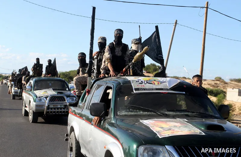 Palestinian militants from the Al-Nasser Brigades, an armed wing of the Popular Resistance Committees (PRC), hold their weapons during a rally in Rafah in the southern Gaza Strip on September 26, 2016, to mark the 17th a...