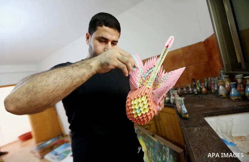 A Palestinian artist Khaled Salama, 27, shows his paper-cutting works at his work shop in the West Bank city of Salfit, on Sep. 27, 2016. Photo by Shadi Hatem