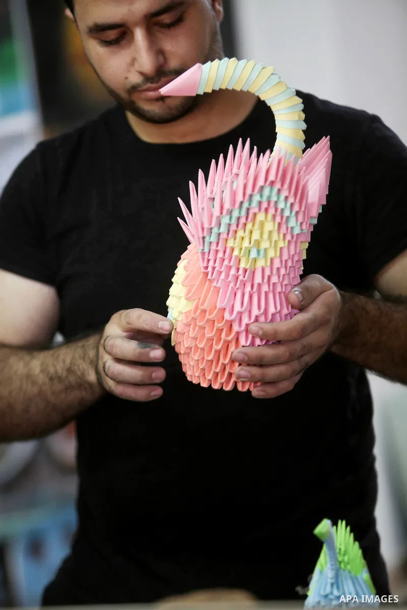 A Palestinian artist Khaled Salama, 27, shows his paper-cutting works at his work shop in the West Bank city of Salfit, on Sep. 27, 2016. Photo by Shadi Hatem