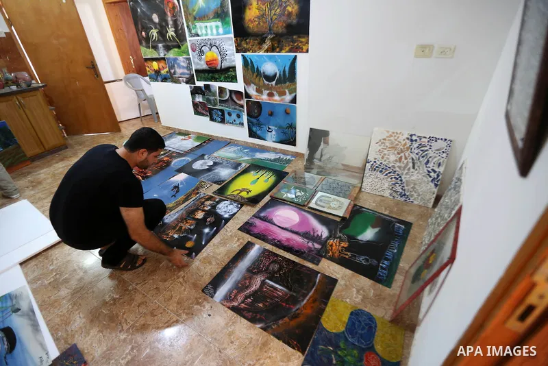 A Palestinian artist Khaled Salama, 27, displays his sand painting, at his work shop in the West Bank city of Salfit, on Sep. 27, 2016. Photo by Shadi Hatem