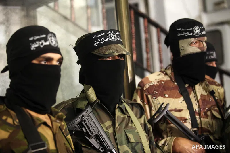 Palestinian militants of the Nasser Salah al-Din Brigades the military wing of the Popular Resistance movement take part in a press conference, in Gaza City on Sept. 27, 2016. Photo by Ashraf Amra