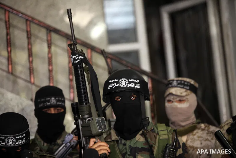 Palestinian militants of the Nasser Salah al-Din Brigades the military wing of the Popular Resistance movement take part in a press conference, in Gaza City on Sept. 27, 2016. Photo by Ashraf Amra