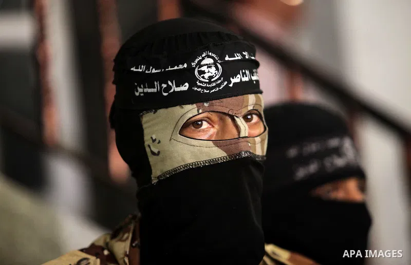Palestinian militants of the Nasser Salah al-Din Brigades the military wing of the Popular Resistance movement take part in a press conference, in Gaza City on Sept. 27, 2016. Photo by Ashraf Amra