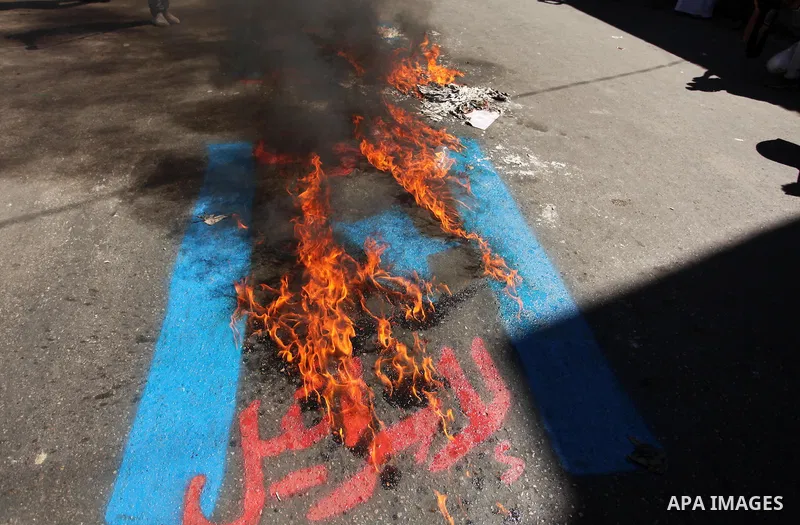 Palestinians burn crossed posters of former Israeli President Shimon Peres, U.S. President Barack Obama and Israeli Prime Minister Benjamin Netanyahu during a rally following Friday prayers in Gaza City September 30, 201...