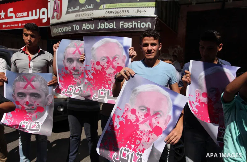 Palestinians hold crossed posters of former Israeli President Shimon Peres, U.S. President Barack Obama and Israeli Prime Minister Benjamin Netanyahu before burning them during a rally following Friday prayers in Gaza Ci...