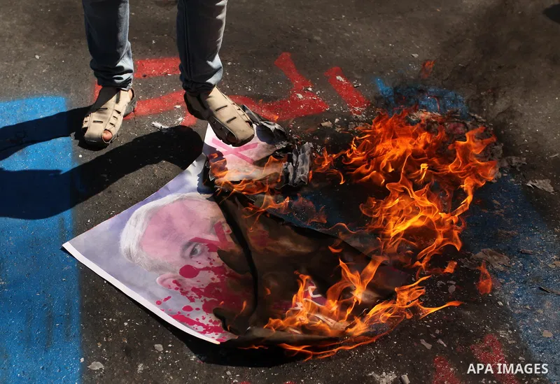 Palestinians burn crossed posters of former Israeli President Shimon Peres, U.S. President Barack Obama and Israeli Prime Minister Benjamin Netanyahu during a rally following Friday prayers in Gaza City September 30, 201...