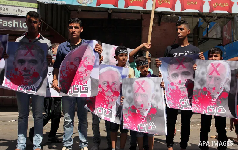 Palestinians hold crossed posters of former Israeli President Shimon Peres, U.S. President Barack Obama and Israeli Prime Minister Benjamin Netanyahu before burning them during a rally following Friday prayers in Gaza Ci...