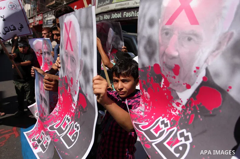 Palestinians hold crossed posters of former Israeli President Shimon Peres, U.S. President Barack Obama and Israeli Prime Minister Benjamin Netanyahu before burning them during a rally following Friday prayers in Gaza Ci...