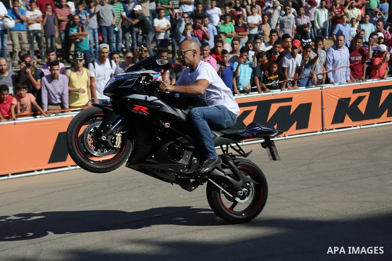 Stunt rider Rok Bagoros demonstrates his skills during a show in the West Bank city of Ramallah September 30, 2016. Photo by Shadi Hatem