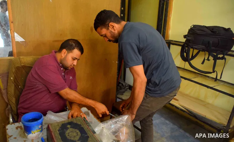 An Egyptian man places a bee on a man suffering from leg problems so it can sting him at a centre in Cairo Out. 01, 2016. Photo by Amr Sayed