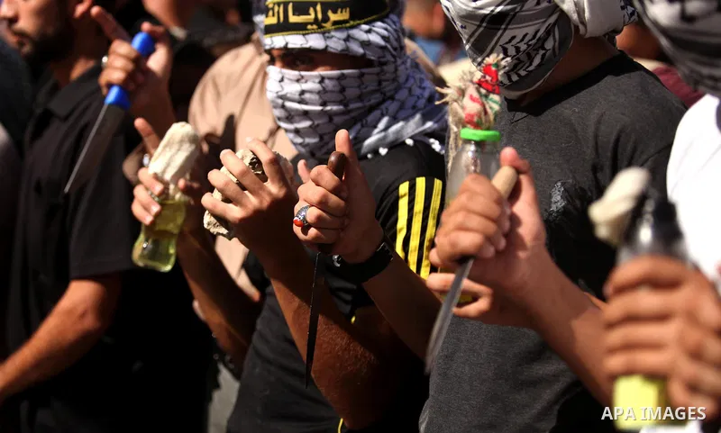 Palestinian supporters of the Islamic Jihad Movement take part in a demonstration marking the first anniversary of the so-called Al-Quds uprising in Gaza city, on October 2, 2016. Photo by Ashraf Amra