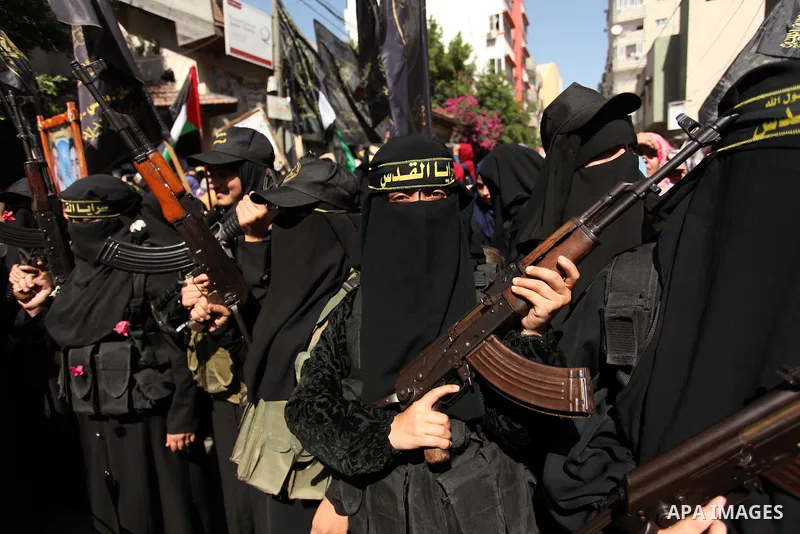 Palestinian women from the Islamic Jihad Movement flash their weapons during a demonstration marking the first anniversary of the so-called Al-Quds uprising in Gaza city, on October 2, 2016. Photo by Ashraf Amra