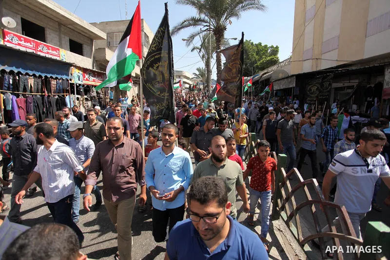 Palestinian supporters of the Islamic Jihad Movement take part in a demonstration marking the first anniversary of the so-called Al-Quds uprising in Gaza city, on October 2, 2016. Photo by Ashraf Amra