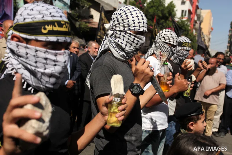 Palestinian supporters of the Islamic Jihad Movement take part in a demonstration marking the first anniversary of the so-called Al-Quds uprising in Gaza city, on October 2, 2016. Photo by Ashraf Amra