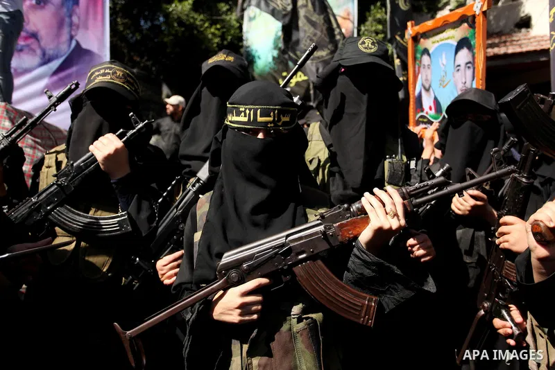 Palestinian women from the Islamic Jihad Movement flash their weapons during a demonstration marking the first anniversary of the so-called Al-Quds uprising in Gaza city, on October 2, 2016. Photo by Ashraf Amra