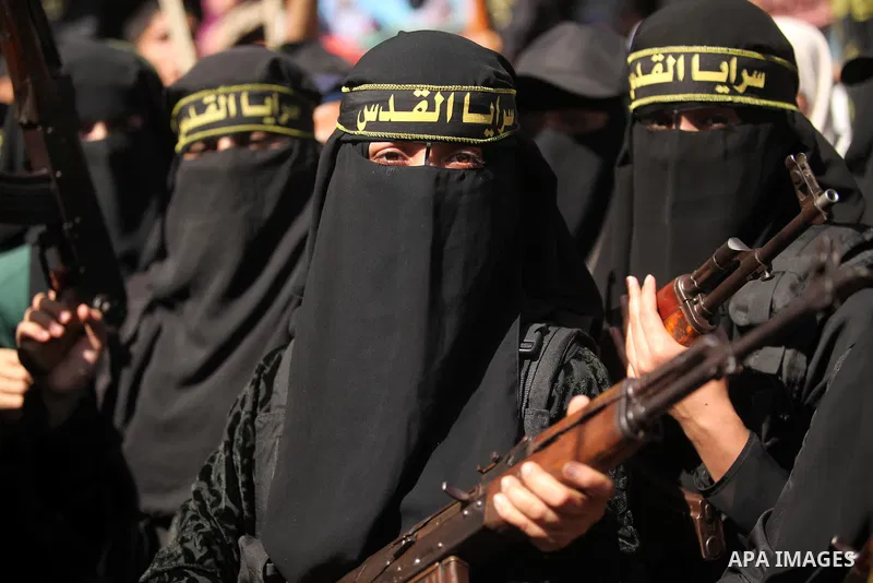 Palestinian women from the Islamic Jihad Movement flash their weapons during a demonstration marking the first anniversary of the so-called Al-Quds uprising in Gaza city, on October 2, 2016. Photo by Ashraf Amra