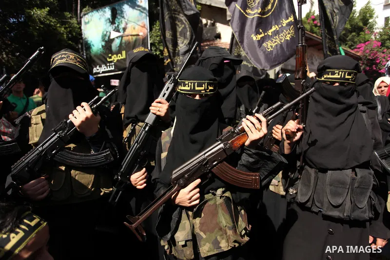 Palestinian women from the Islamic Jihad Movement flash their weapons during a demonstration marking the first anniversary of the so-called Al-Quds uprising in Gaza city, on October 2, 2016. Photo by Ashraf Amra