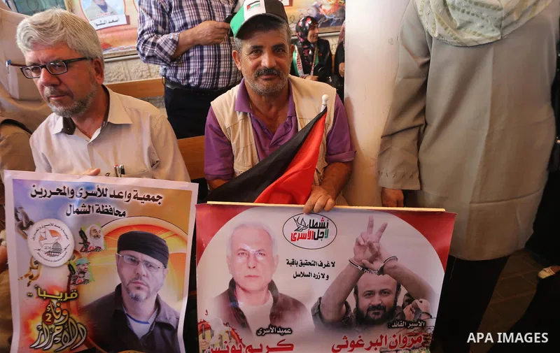 Palestinians take part during a protest to show solidarity with Palestinian prisoners on hunger strike in Israeli Jails, in front of Red cross office in Gaza city, on Oct. 03, 2016. Photo by Mohammed Asad