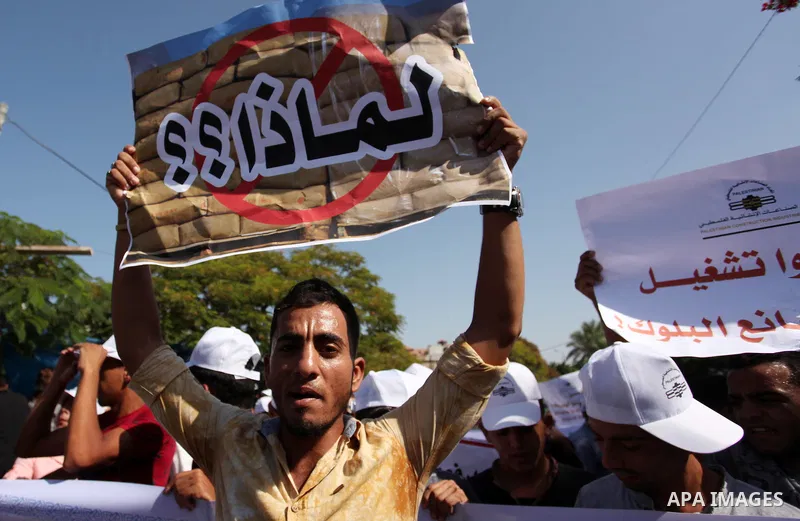 Palestinian owners of factories hold banners during a protest against israeli blockade on operations their factories, in front of the headquarter United Nation "UNSCO", in Gaza city, on October 4, 2016. Photo by Ashraf A...