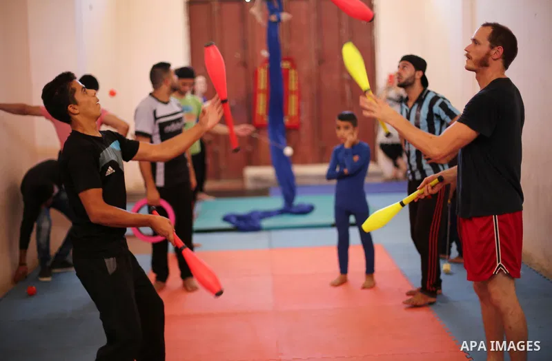 Members of Gaza Circus practice juggling with clubs and rings in Beit Lahiya in the northern Gaza Strip, on oct. 04, 2016. Jennifer Higgins, Nathalie Marquez Courtney from Ireland and Henrick Gard from Sweden are train P...
