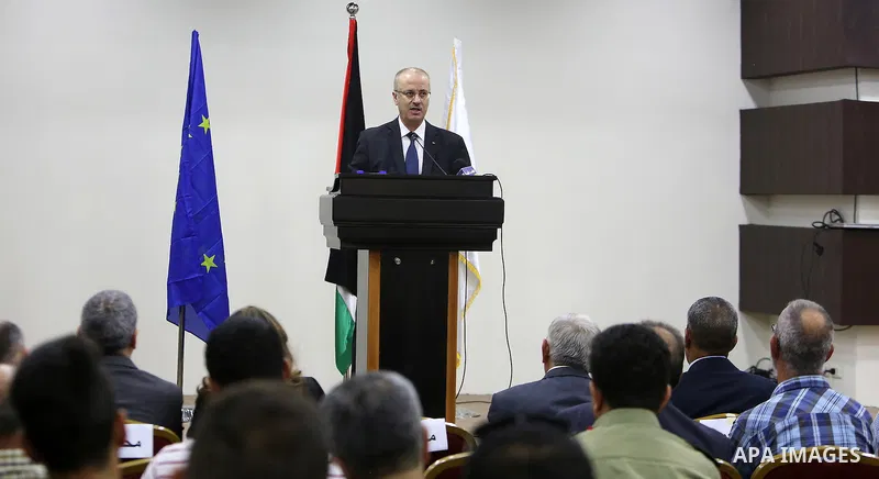 Palestinian Prime Minister, Rami Hamdallah, attends the launch of the national plan for sustainable production and consumption, in the West bank city of Ramallah, Oct. 05, 2016. Photo by Prime Minister Office