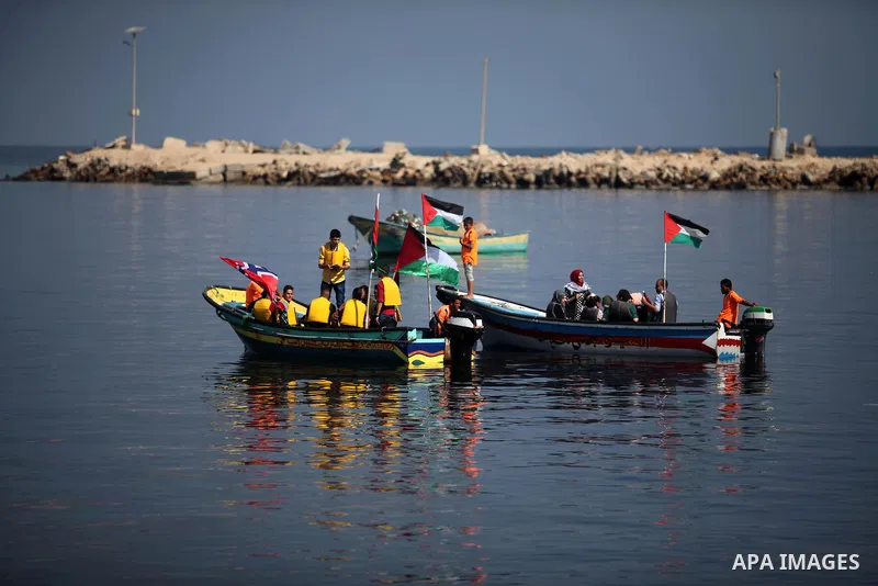Palestinians show their solidarity with a Gaza-bound flotilla of international activists attempting to break the Israeli blockade on the Hamas-run Gaza Strip, on October 5, 2016 at the port in Gaza City. A group of women...