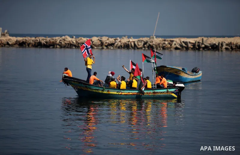 Palestinians show their solidarity with a Gaza-bound flotilla of international activists attempting to break the Israeli blockade on the Hamas-run Gaza Strip, on October 5, 2016 at the port in Gaza City. A group of women...