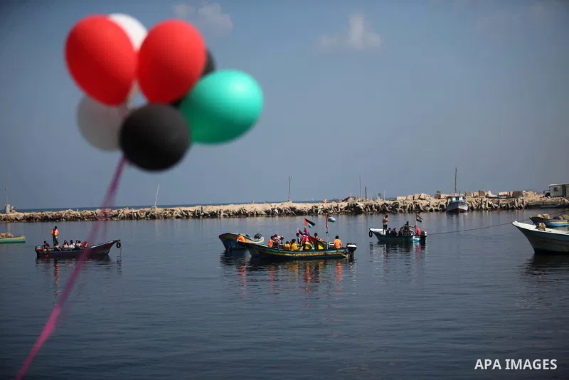 Palestinians show their solidarity with a Gaza-bound flotilla of international activists attempting to break the Israeli blockade on the Hamas-run Gaza Strip, on October 5, 2016 at the port in Gaza City. A group of women...