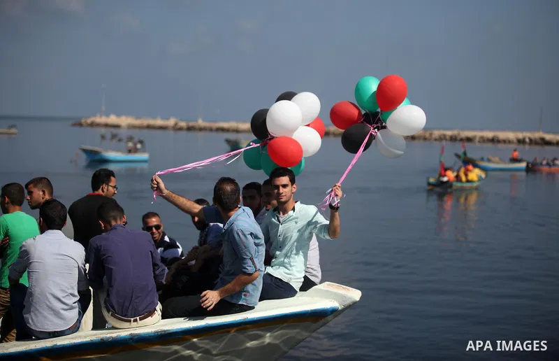 Palestinians show their solidarity with a Gaza-bound flotilla of international activists attempting to break the Israeli blockade on the Hamas-run Gaza Strip, on October 5, 2016 at the port in Gaza City. A group of women...
