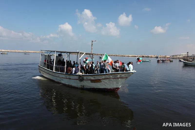 Palestinians show their solidarity with a Gaza-bound flotilla of international activists attempting to break the Israeli blockade on the Hamas-run Gaza Strip, on October 5, 2016 at the port in Gaza City. A group of women...