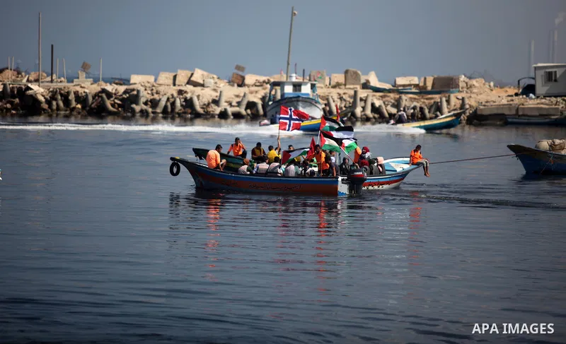Palestinians show their solidarity with a Gaza-bound flotilla of international activists attempting to break the Israeli blockade on the Hamas-run Gaza Strip, on October 5, 2016 at the port in Gaza City. A group of women...