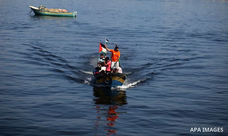 Palestinians show their solidarity with a Gaza-bound flotilla of international activists attempting to break the Israeli blockade on the Hamas-run Gaza Strip, on October 5, 2016 at the port in Gaza City. A group of women...