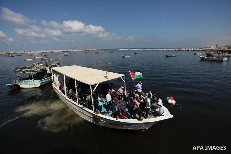Palestinians show their solidarity with a Gaza-bound flotilla of international activists attempting to break the Israeli blockade on the Hamas-run Gaza Strip, on October 5, 2016 at the port in Gaza City. A group of women...
