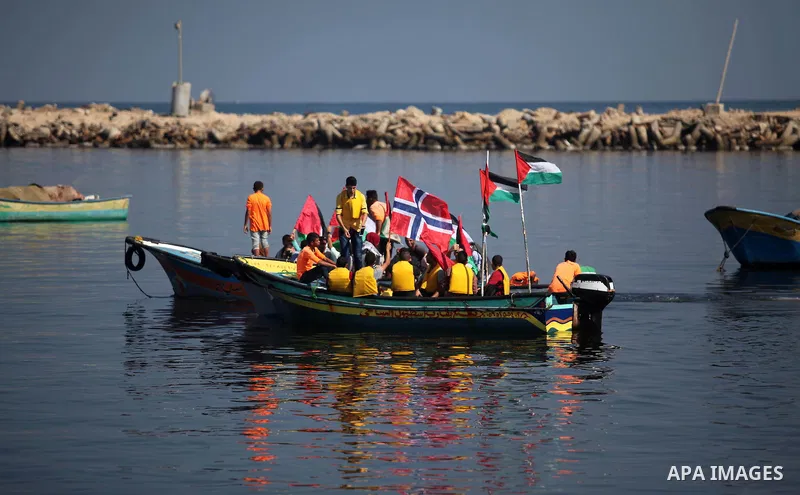 Palestinians show their solidarity with a Gaza-bound flotilla of international activists attempting to break the Israeli blockade on the Hamas-run Gaza Strip, on October 5, 2016 at the port in Gaza City. A group of women...