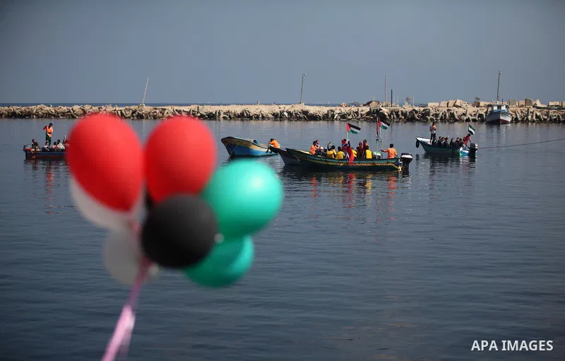 Palestinians show their solidarity with a Gaza-bound flotilla of international activists attempting to break the Israeli blockade on the Hamas-run Gaza Strip, on October 5, 2016 at the port in Gaza City. A group of women...