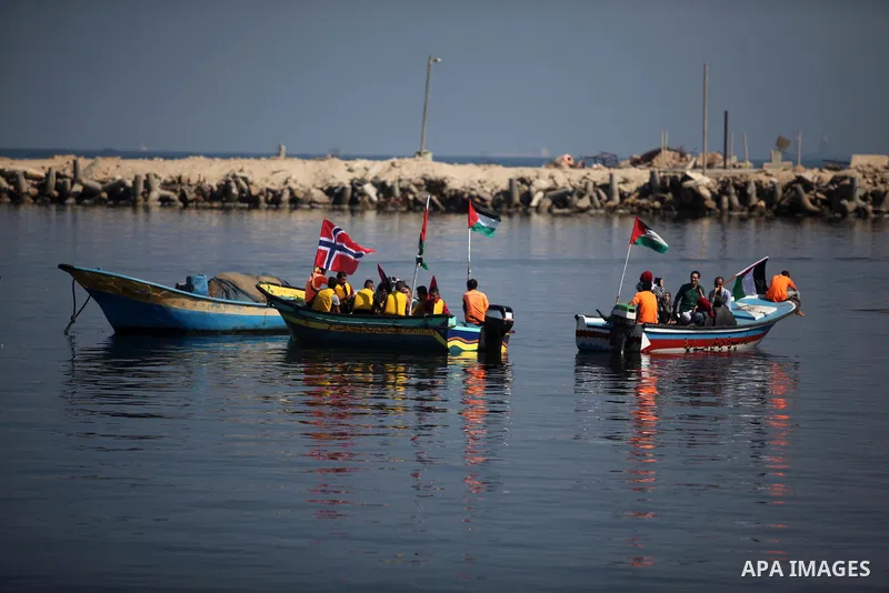 Palestinians show their solidarity with a Gaza-bound flotilla of international activists attempting to break the Israeli blockade on the Hamas-run Gaza Strip, on October 5, 2016 at the port in Gaza City. A group of women...