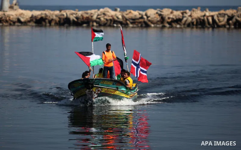 Palestinians show their solidarity with a Gaza-bound flotilla of international activists attempting to break the Israeli blockade on the Hamas-run Gaza Strip, on October 5, 2016 at the port in Gaza City. A group of women...