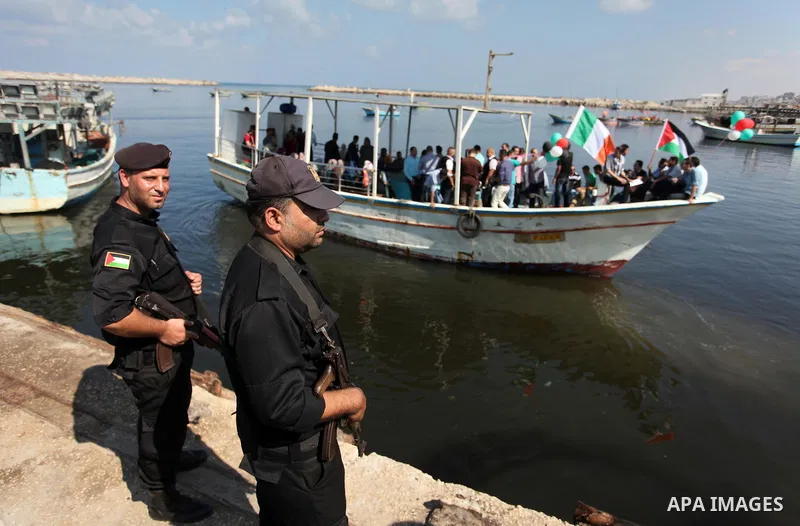 Palestinians show their solidarity with a Gaza-bound flotilla of international activists attempting to break the Israeli blockade on the Hamas-run Gaza Strip, on October 5, 2016 at the port in Gaza City. A group of women...