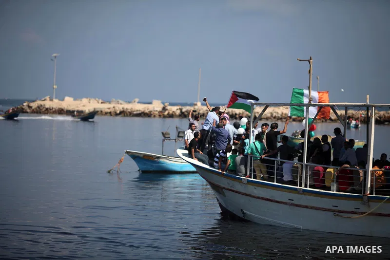 Palestinians show their solidarity with a Gaza-bound flotilla of international activists attempting to break the Israeli blockade on the Hamas-run Gaza Strip, on October 5, 2016 at the port in Gaza City. A group of women...