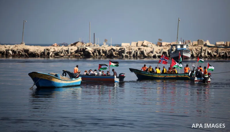 Palestinians show their solidarity with a Gaza-bound flotilla of international activists attempting to break the Israeli blockade on the Hamas-run Gaza Strip, on October 5, 2016 at the port in Gaza City. A group of women...