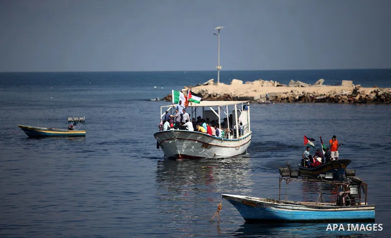 Palestinians show their solidarity with a Gaza-bound flotilla of international activists attempting to break the Israeli blockade on the Hamas-run Gaza Strip, on October 5, 2016 at the port in Gaza City. A group of women...