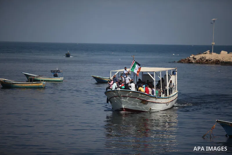 Palestinians show their solidarity with a Gaza-bound flotilla of international activists attempting to break the Israeli blockade on the Hamas-run Gaza Strip, on October 5, 2016 at the port in Gaza City. A group of women...