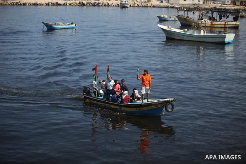 Palestinians show their solidarity with a Gaza-bound flotilla of international activists attempting to break the Israeli blockade on the Hamas-run Gaza Strip, on October 5, 2016 at the port in Gaza City. A group of women...