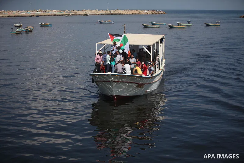 Palestinians show their solidarity with a Gaza-bound flotilla of international activists attempting to break the Israeli blockade on the Hamas-run Gaza Strip, on October 5, 2016 at the port in Gaza City. A group of women...