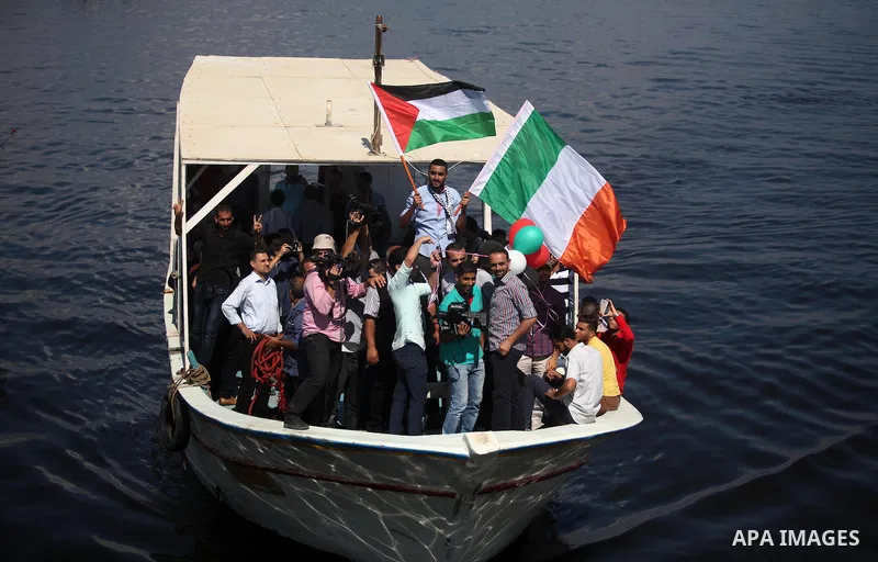 Palestinians show their solidarity with a Gaza-bound flotilla of international activists attempting to break the Israeli blockade on the Hamas-run Gaza Strip, on October 5, 2016 at the port in Gaza City. A group of women...