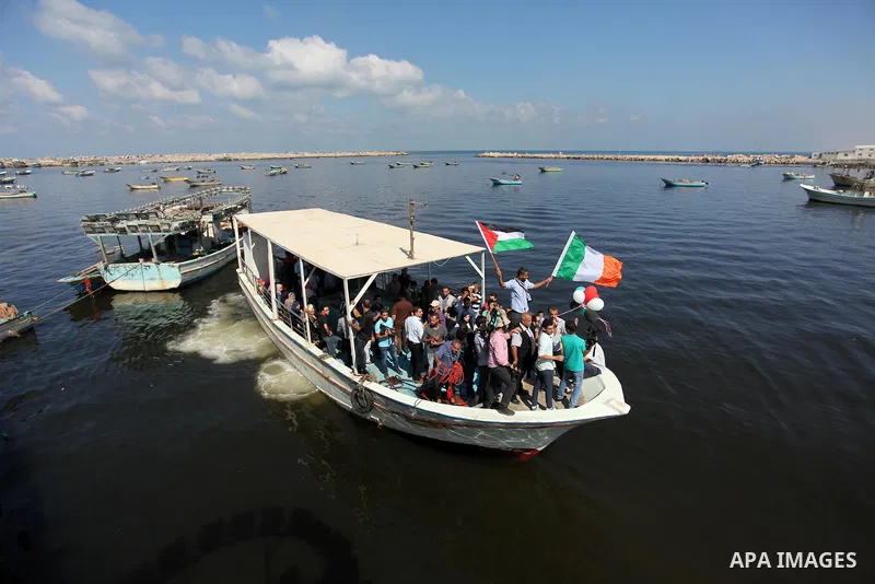 Palestinians show their solidarity with a Gaza-bound flotilla of international activists attempting to break the Israeli blockade on the Hamas-run Gaza Strip, on October 5, 2016 at the port in Gaza City. A group of women...